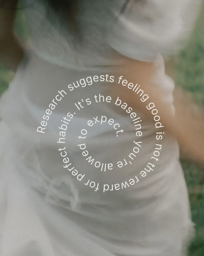 Spiral of text over a soft-focus photo: Research suggests feeling good is not the reward for perfect habits. It's the baseline you're allowed to expect.
